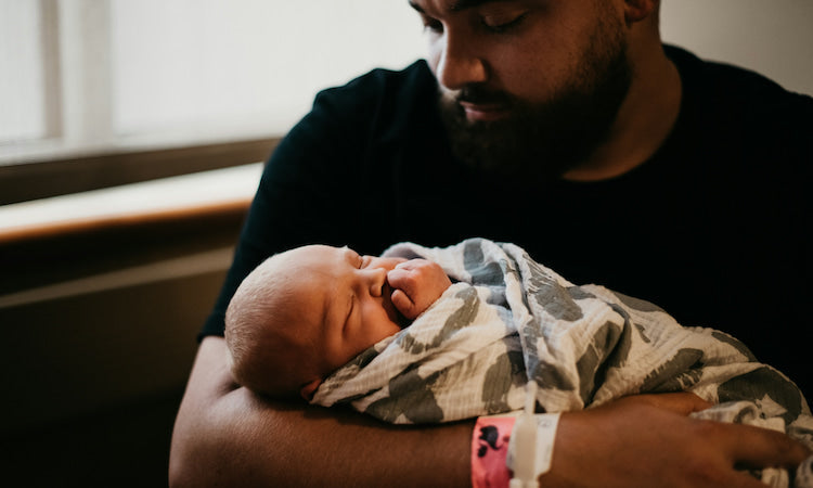 Dad holding newborn baby