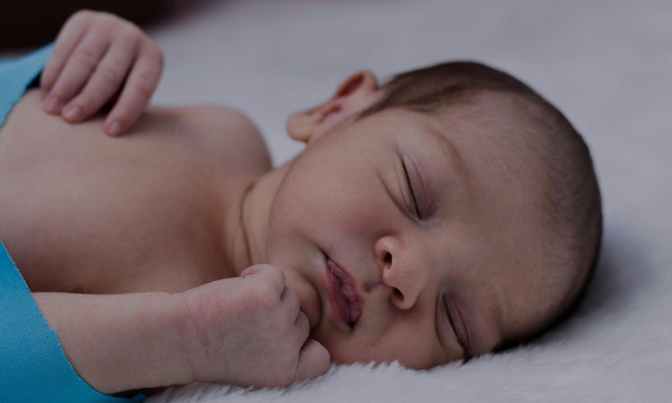 Newborn sleeping on their side