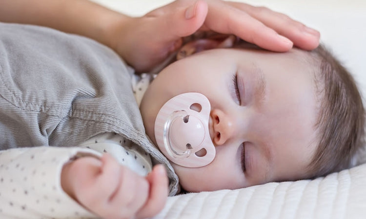 Newborn sleeping with pacifier